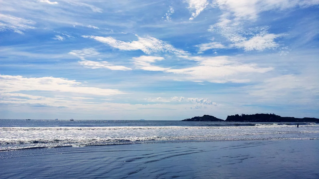 Prainha de Peruíbe, em Peruíbe (SP): Mar e céu azul na Prainha, com ilhotas no horizonte, em Peruíbe (SP)